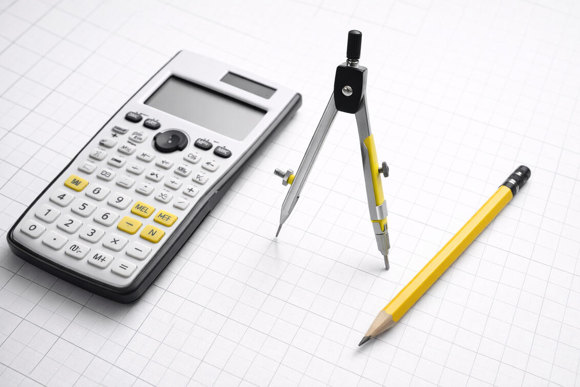 Calculator, compass, and pencil representing calm, precise, structured tradin tools.